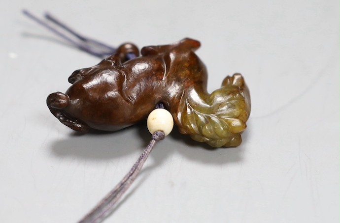 A Chinese green and brown jade ‘horse’ toggle. 4.5cm